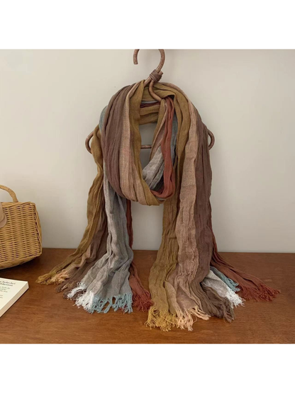 Crinkled multicolor scarf in muted tan, rust and mustard tones with fringed ends