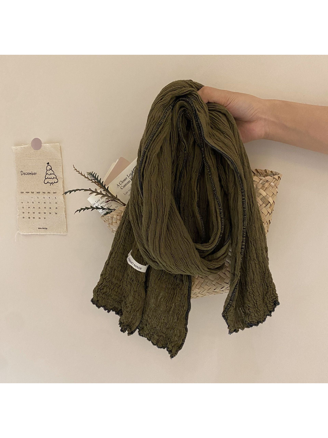 Olive green crinkled scarf with dark contrast edge trim