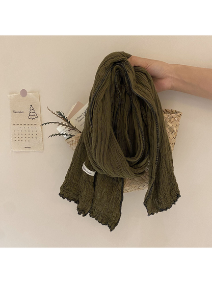 Olive green crinkled scarf with dark contrast edge trim