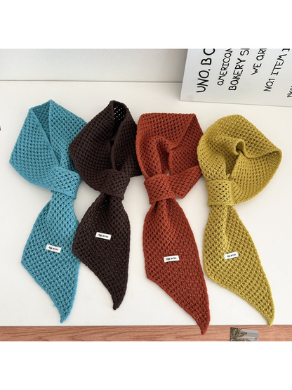 Lake blue, dark brown, orange-brown and mustard yellow pull-through scarves displayed together