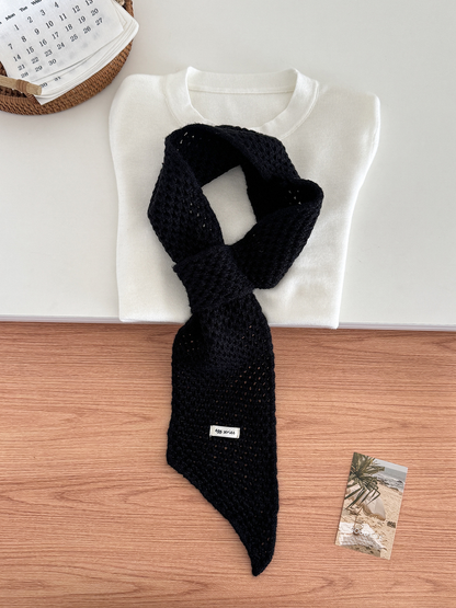 Black openwork pull-through scarf displayed with a folded white top
