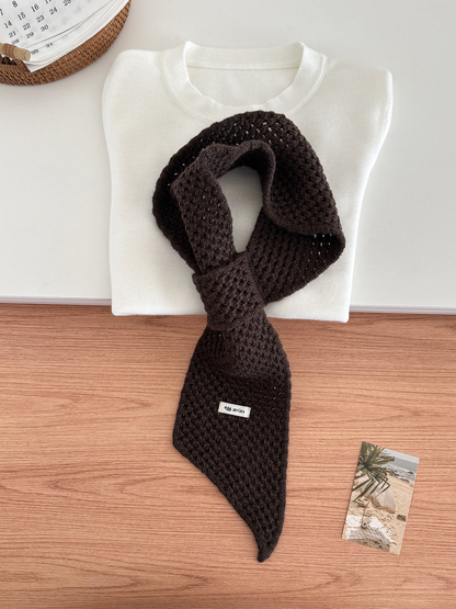 Dark Brown openwork pull-through scarf displayed with a folded white top
