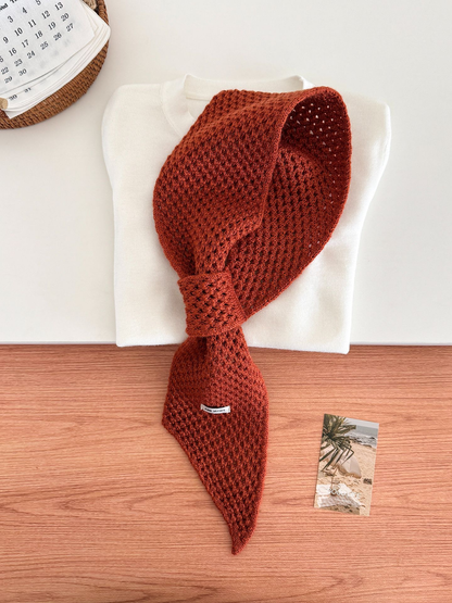 Orange and Brown openwork pull-through scarf displayed with a folded white top