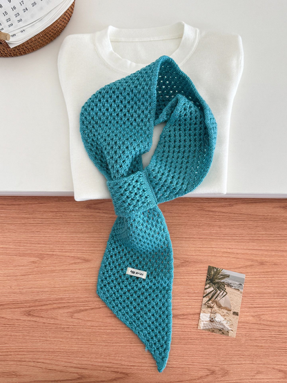 Lake Blue openwork pull-through scarf displayed with a folded white top