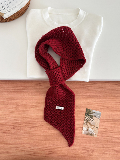 Burgundy openwork pull-through scarf displayed with a folded white top