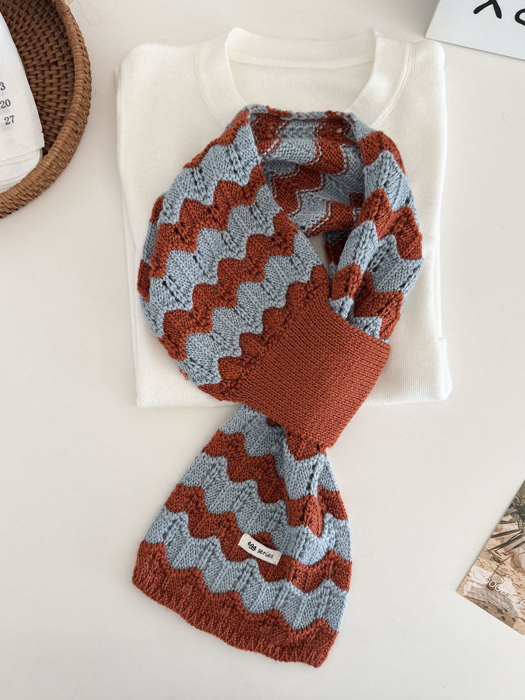 Blue and orange wavy knit pull-through scarf displayed flat