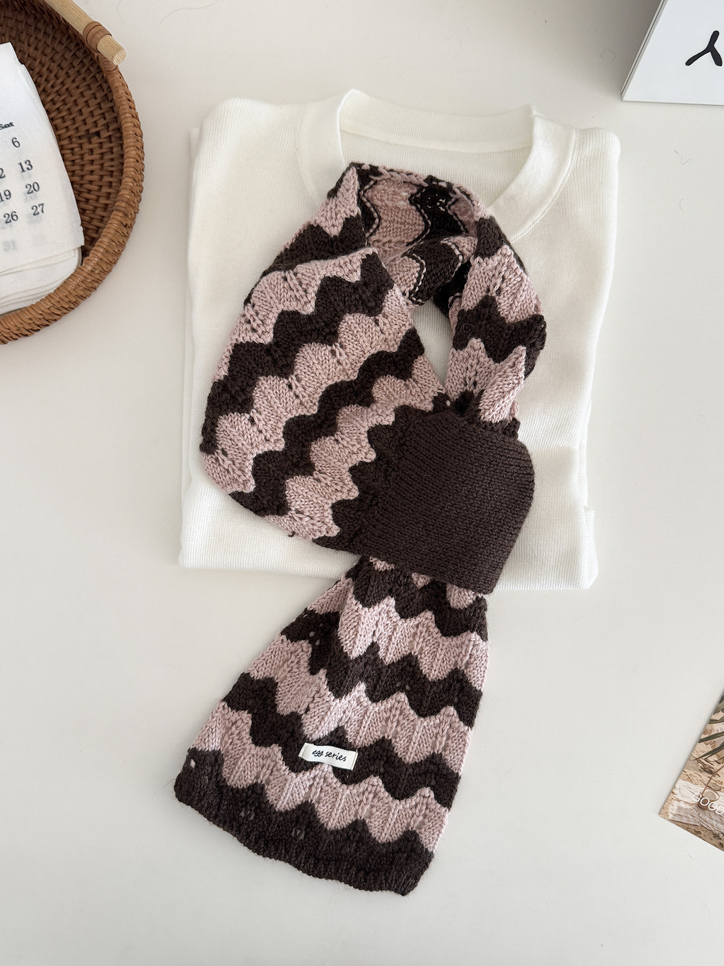 Brown and pink wavy knit pull-through scarf displayed flat