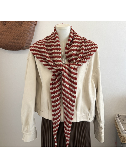Burgundy striped triangle scarf styled over a cream jacket