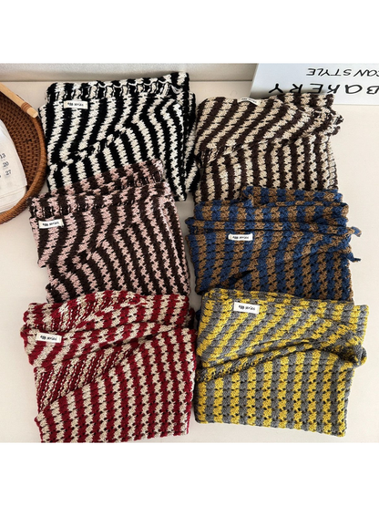Multiple striped triangle scarf colors folded together