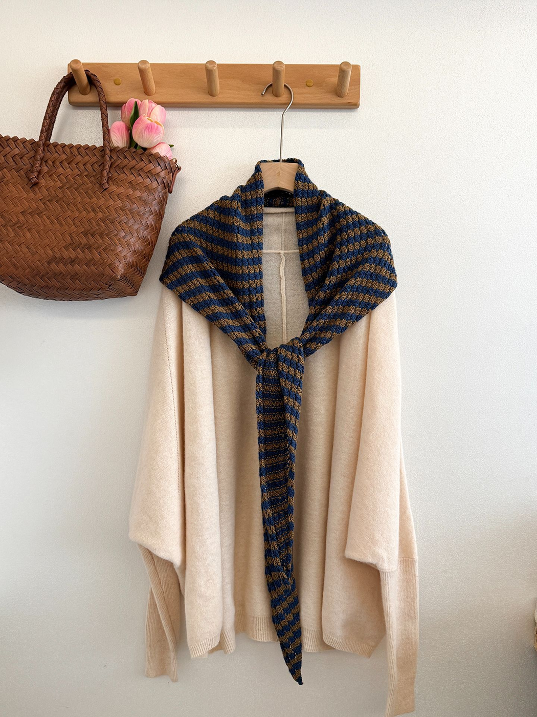 Blue and Coffee striped triangle scarf styled over a draped cream garment