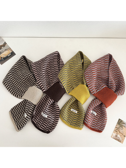 Four color variations of the geometric pull-through scarf arranged side by side