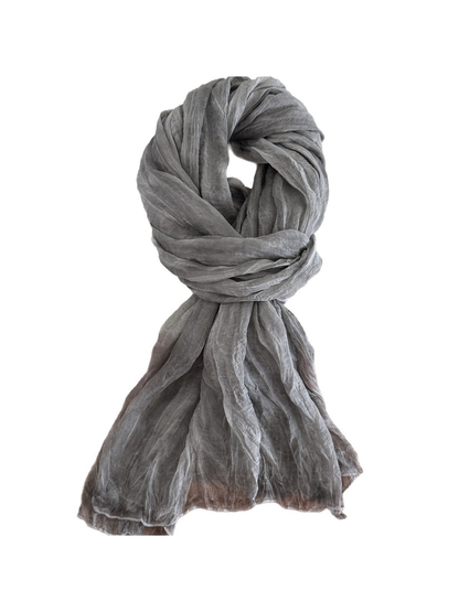 Gray crinkled scarf arranged against a white background