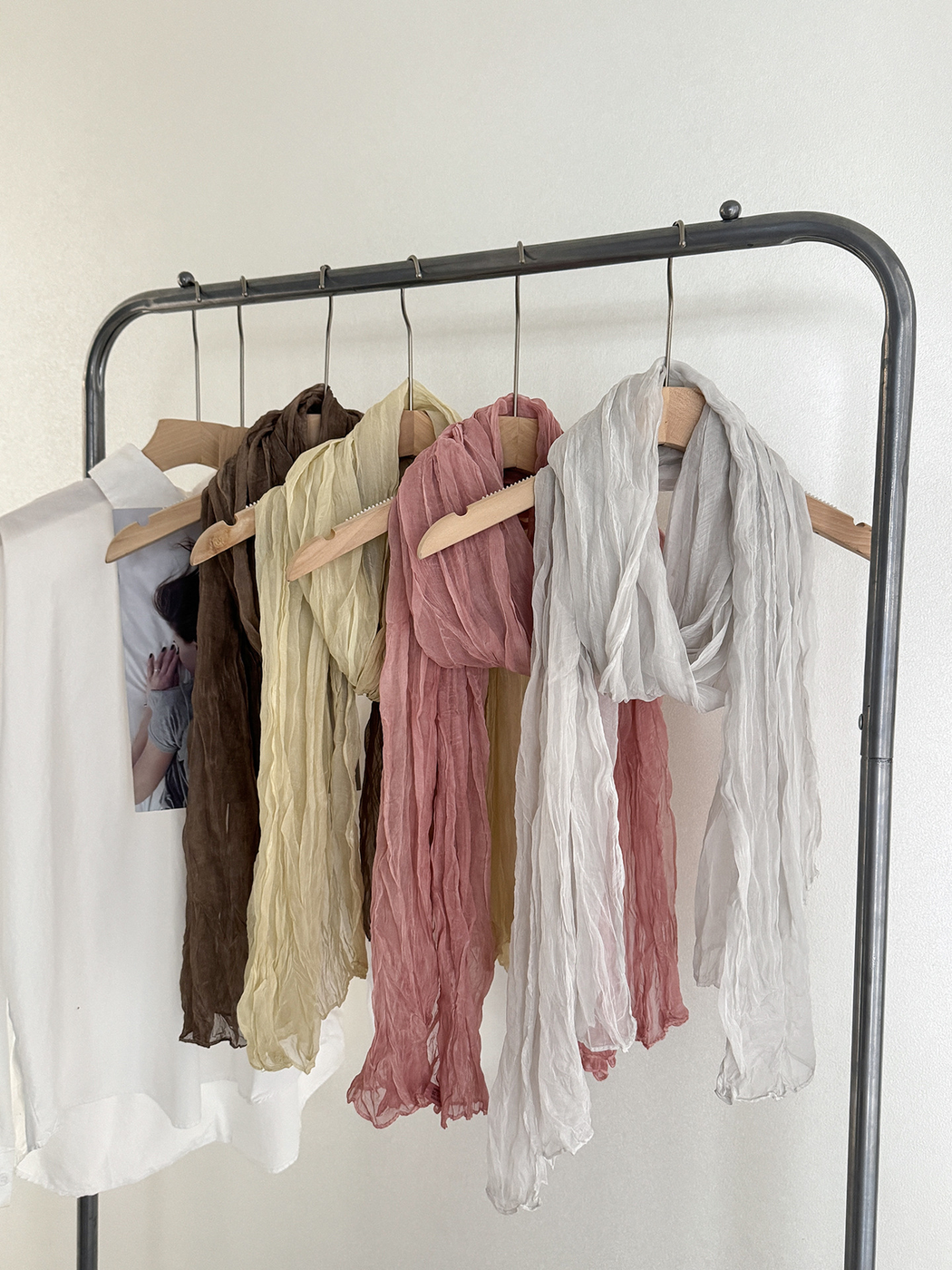 Dark brown, cream, dusty pink and white crinkled scarves displayed together