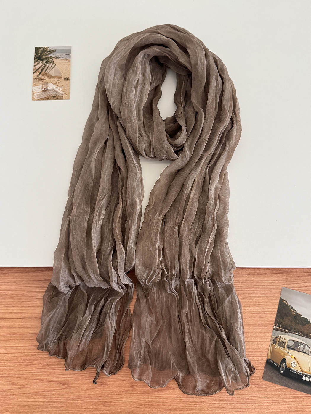 Dark Brown crinkled scarf arranged in a long drape