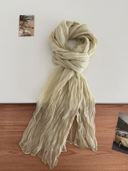 Cream crinkled scarf arranged in a long drape