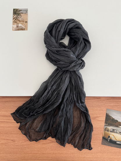 Black crinkled scarf arranged in a long drape