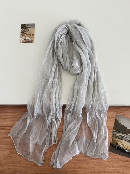 White crinkled scarf arranged in a long drape