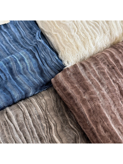 Close-up of blue, cream, brown and gray crinkled scarf textures