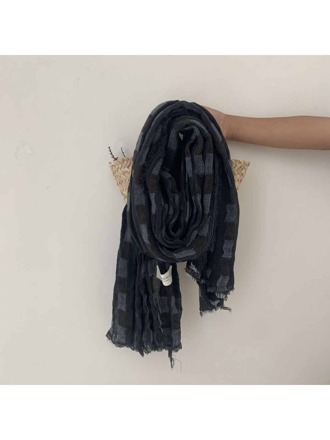 Black checked scarf with an open weave and fringed edges