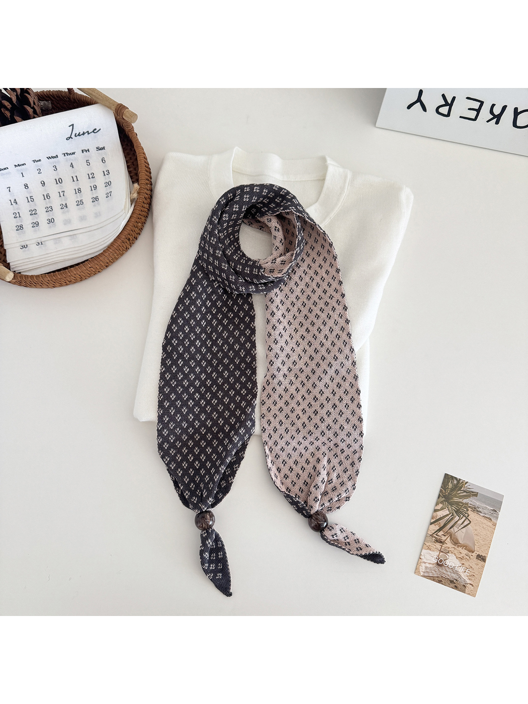 Pink geometric-patterned narrow scarf with bead accents