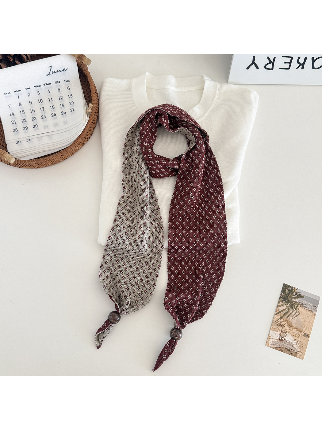 Burgundy geometric-patterned narrow scarf with contrasting reverse and bead accents