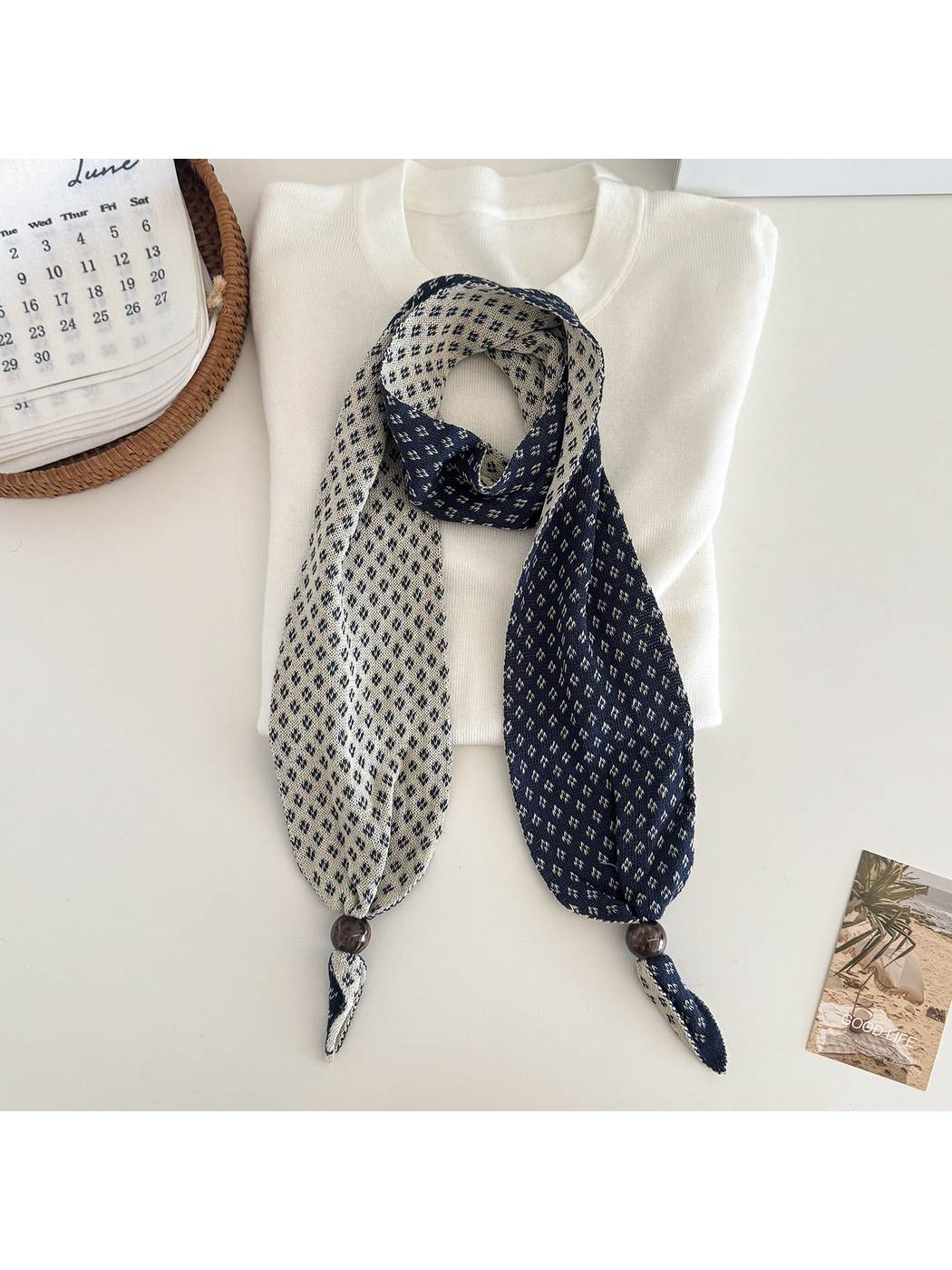 Navy geometric-patterned narrow scarf with contrasting reverse and bead accents