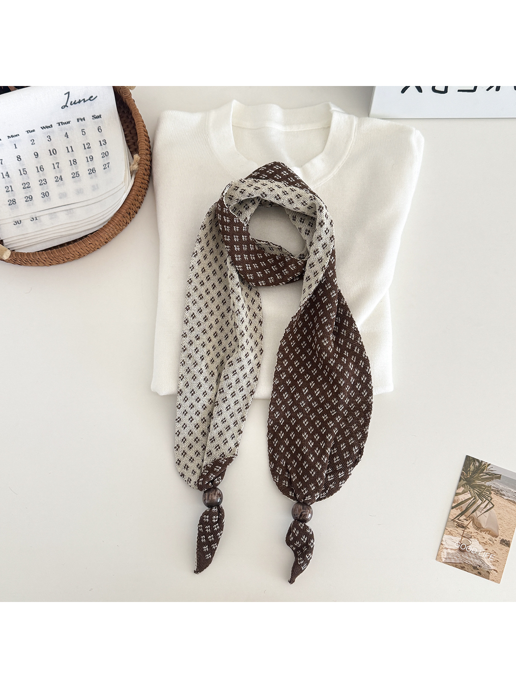 Brown geometric-patterned narrow scarf with contrasting reverse and bead accents