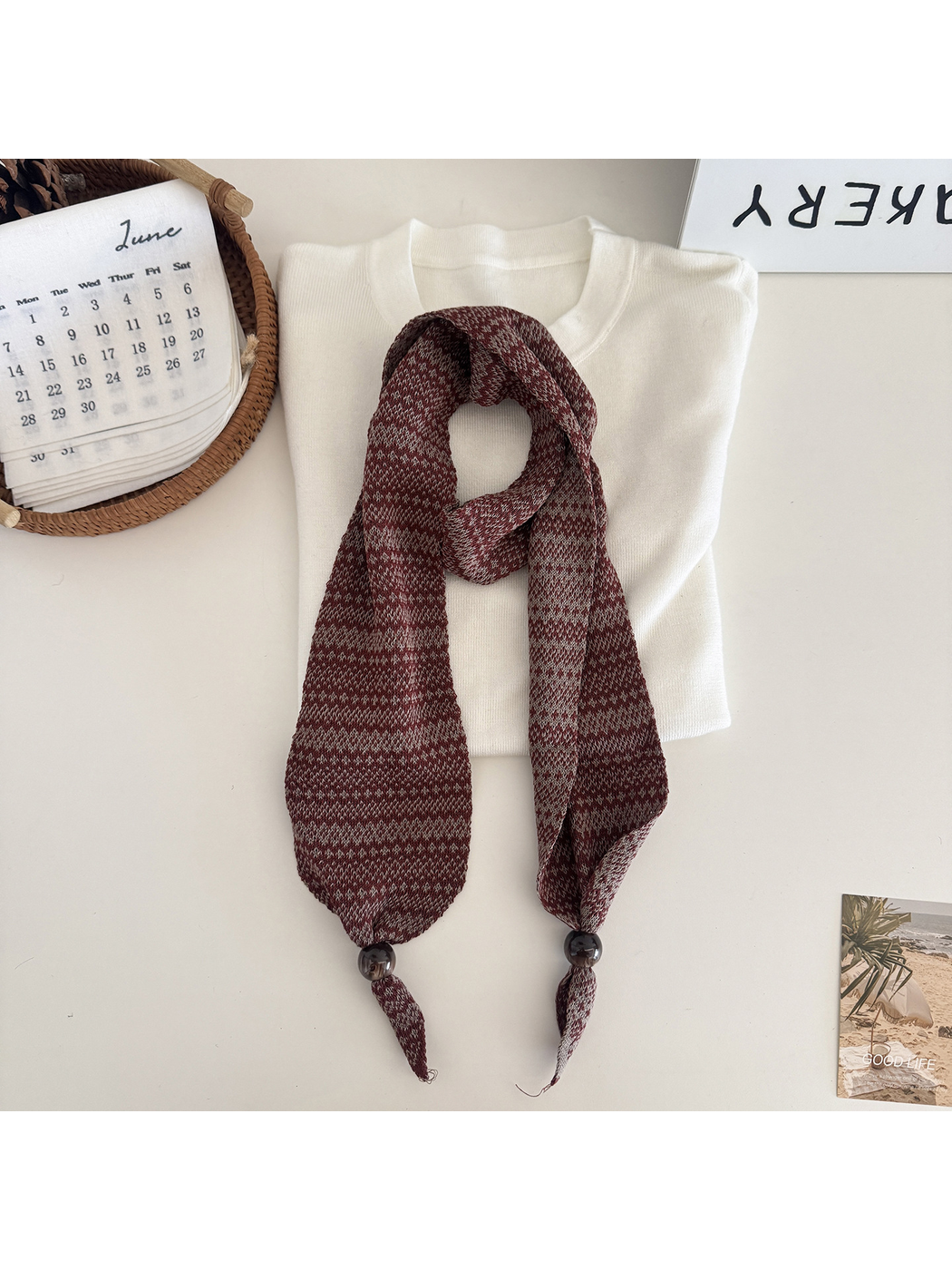 Brown geometric-pattern narrow scarf with bead accents, flat display