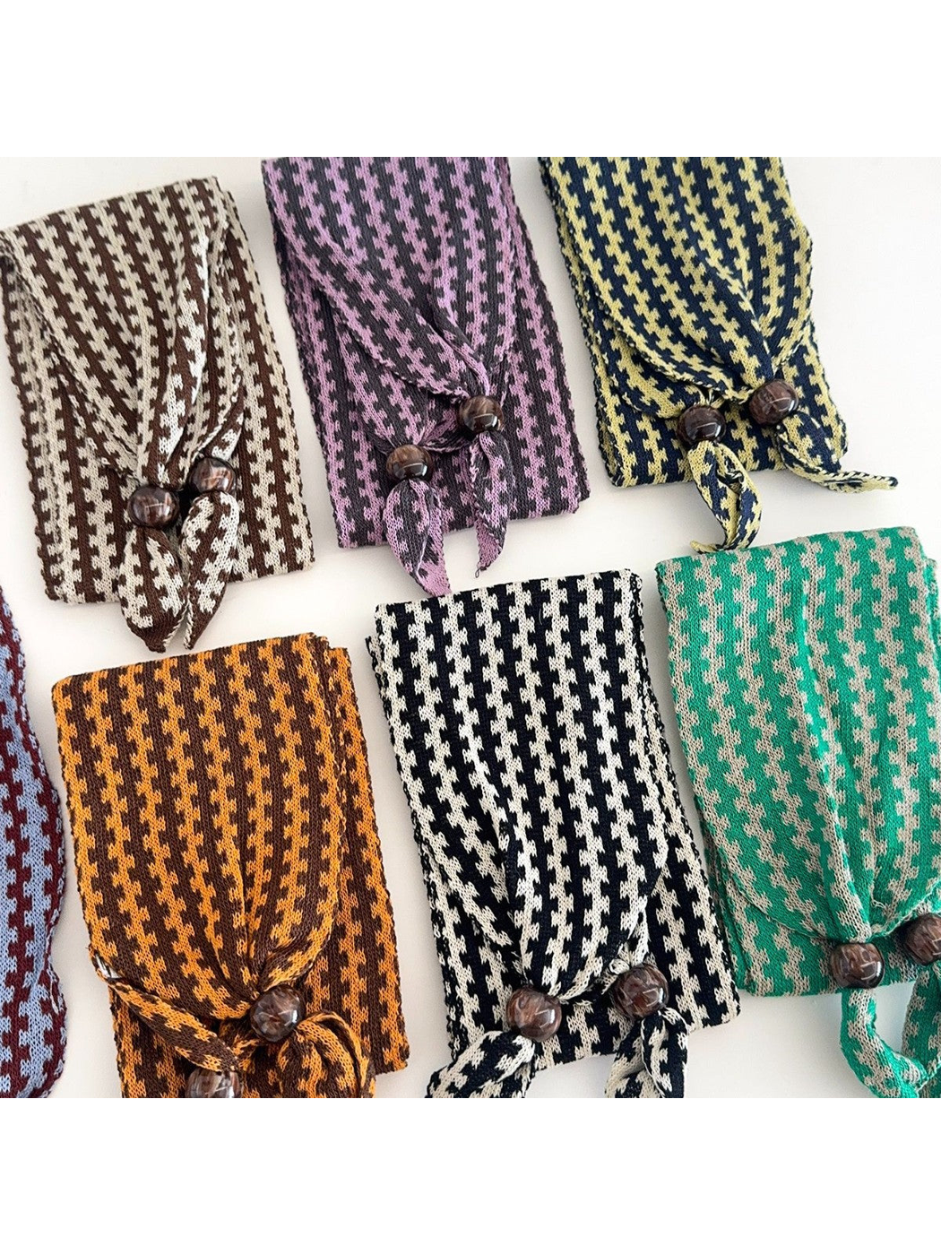 Close-up of the repeating geometric pattern and dark round end beads