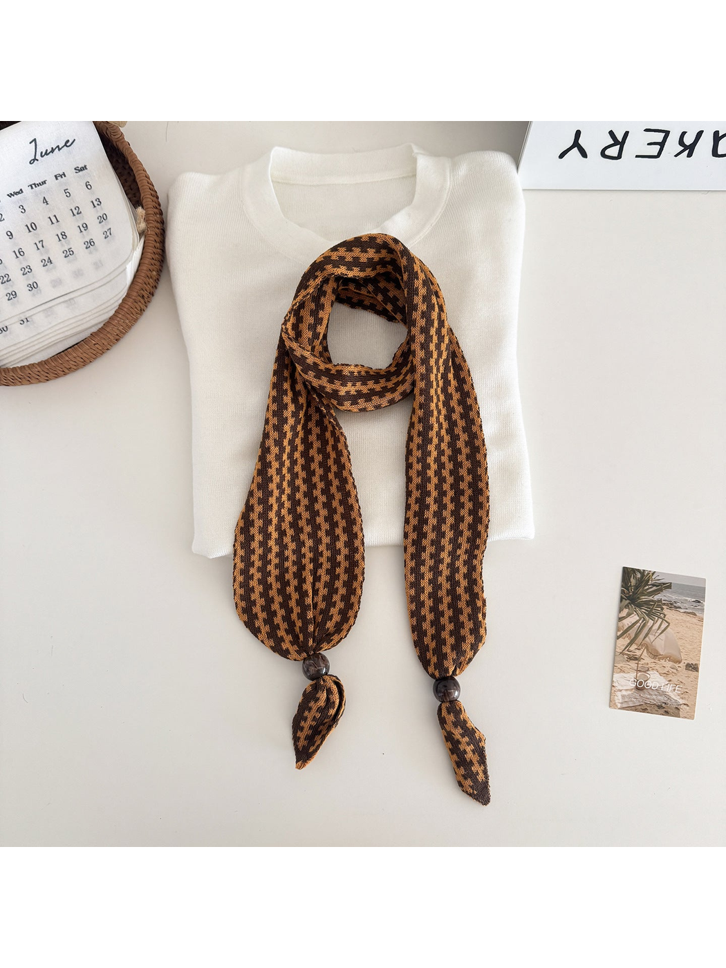 Orange / Brown narrow patterned scarf with dark round end beads