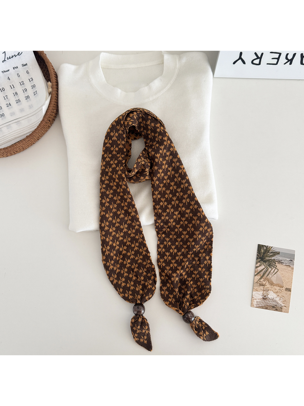 Orange and brown patterned narrow scarf with beaded tapered ends