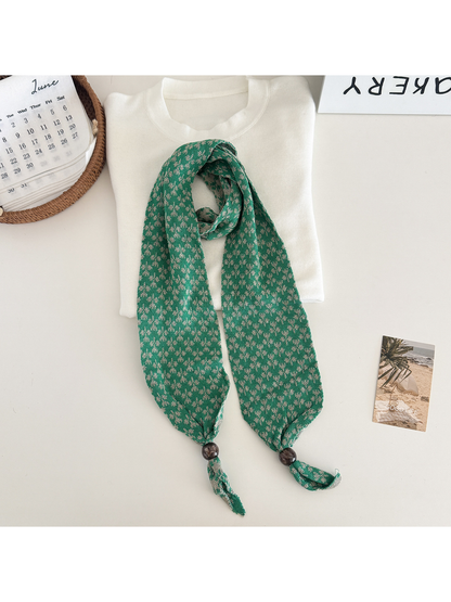 Dark green patterned narrow scarf with beaded tapered ends