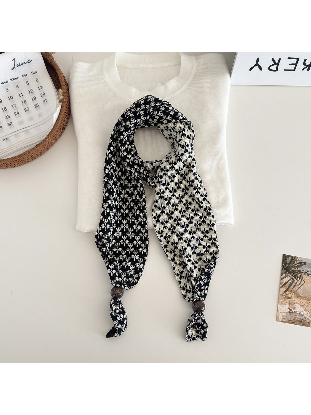 Black and white patterned narrow scarf with beaded tapered ends