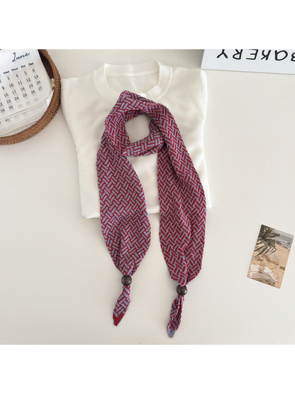 Red Blue geometric narrow scarf with beaded pointed ends, flat lay