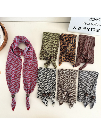 Seven geometric narrow scarf styles arranged on a tabletop