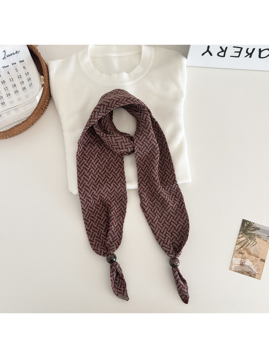 Burgundy Brown geometric narrow scarf with beaded pointed ends, flat lay