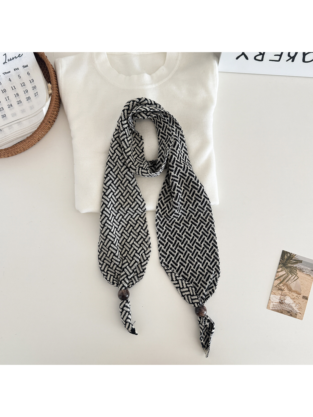 Black White geometric narrow scarf with beaded pointed ends, flat lay