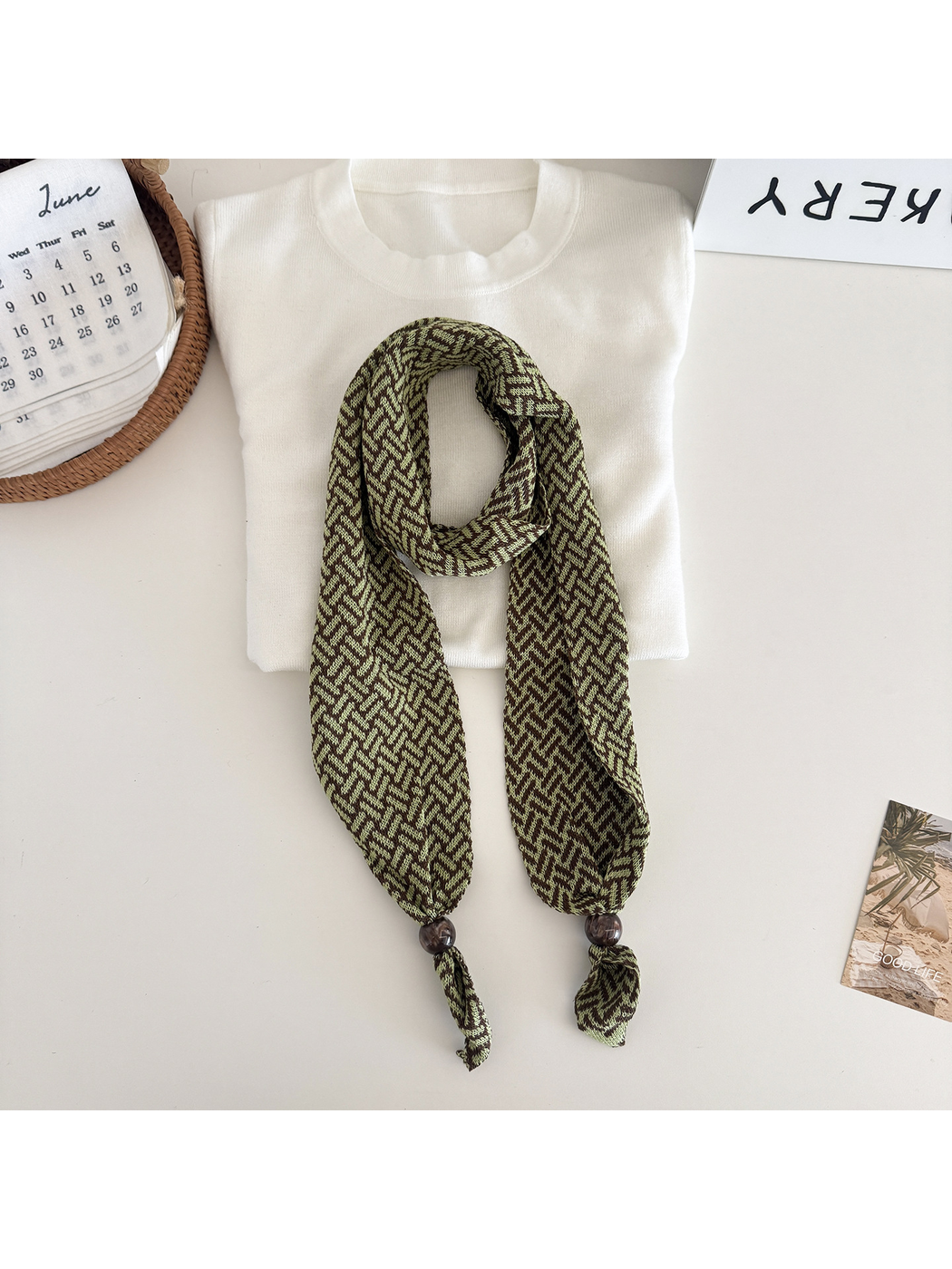 Olive Green geometric narrow scarf with beaded pointed ends, flat lay