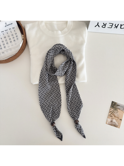 Gray Black geometric narrow scarf with beaded pointed ends, flat lay