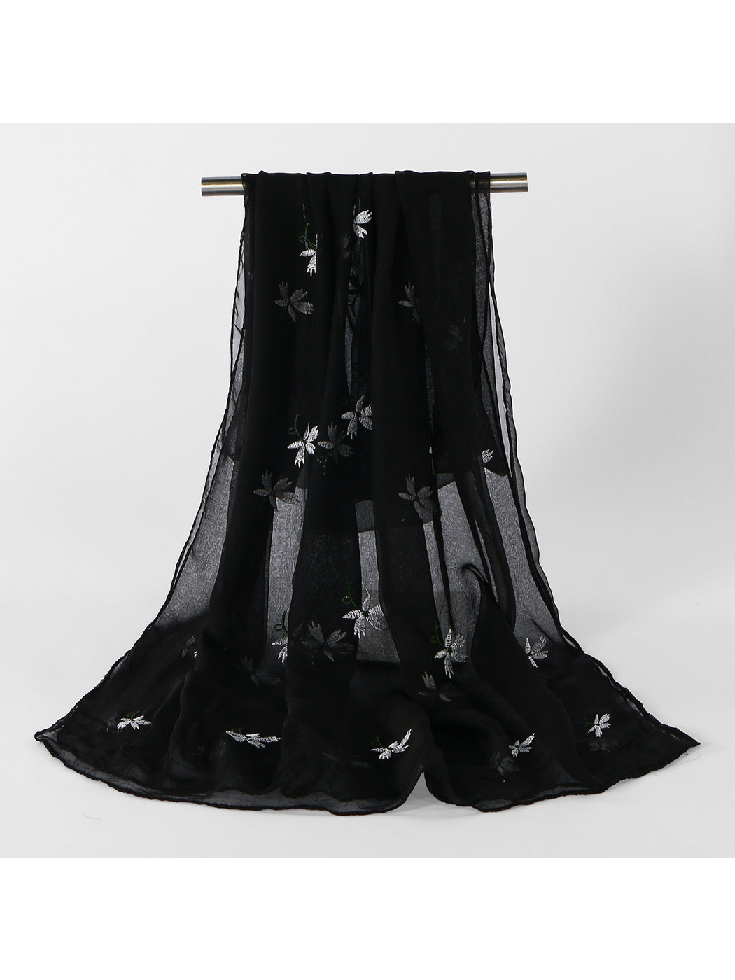 Black sheer scarf with scattered white floral embroidery, draped view