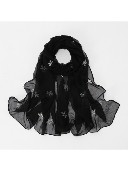 Black sheer floral scarf arranged in a looped styling view