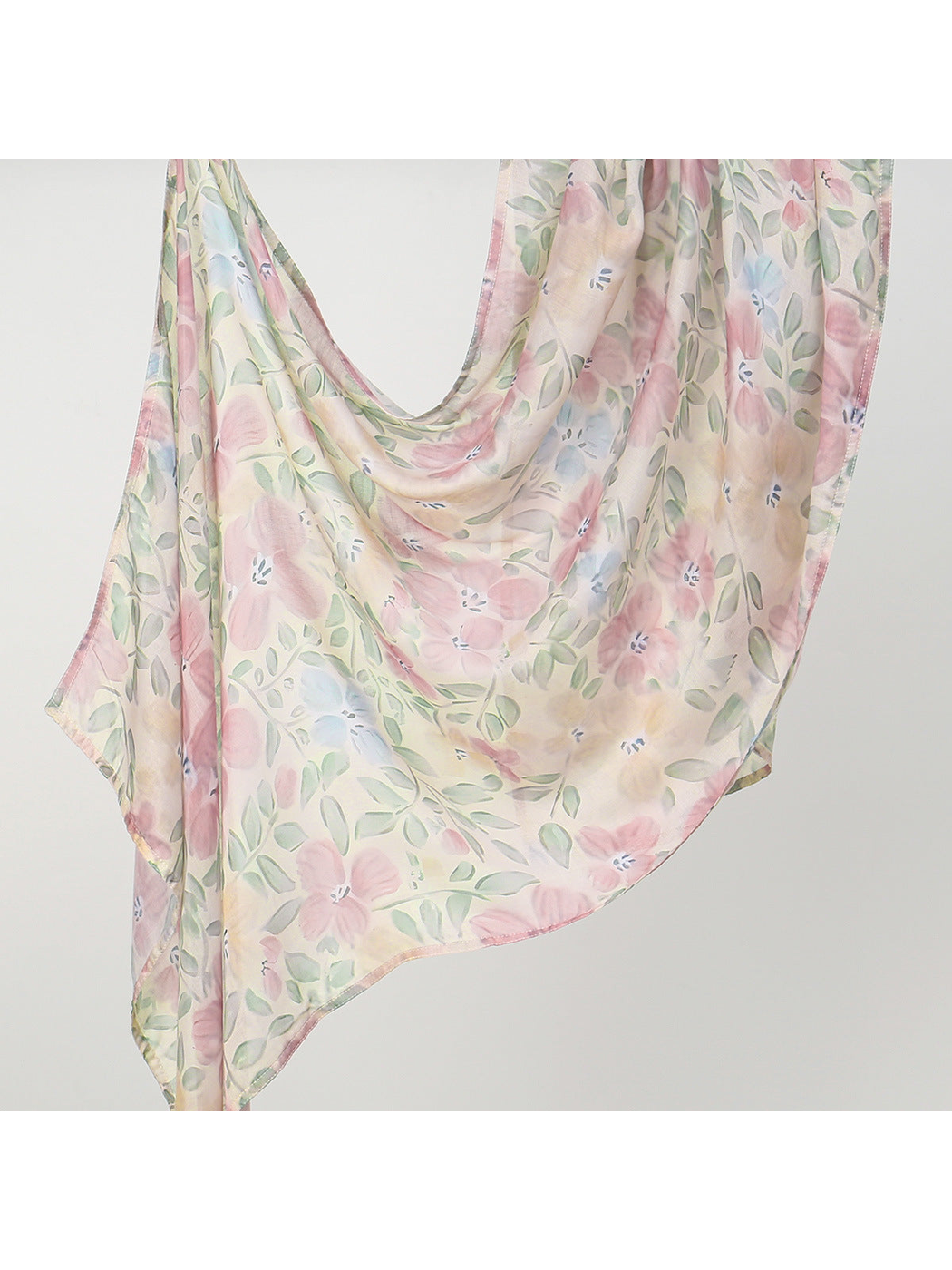 Cream-toned scarf with pink flowers and muted green leaves