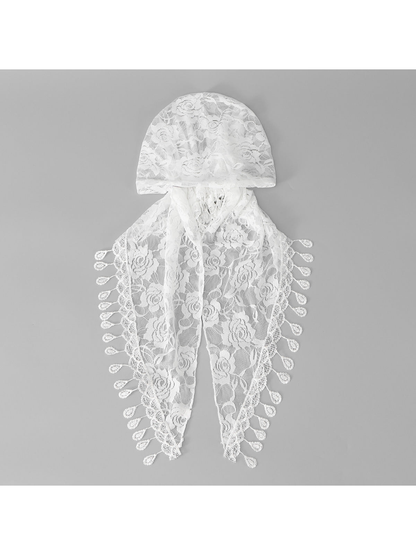 White floral lace cap-style headscarf with teardrop fringe, flat lay