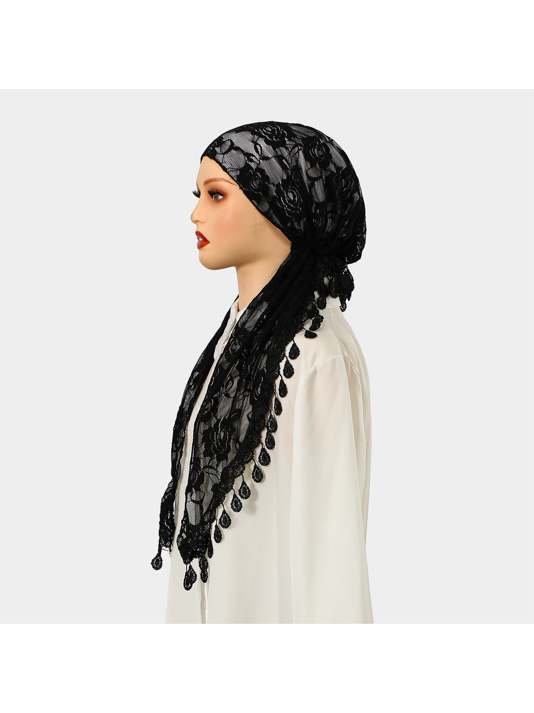 Black floral lace headscarf displayed on a mannequin, profile view