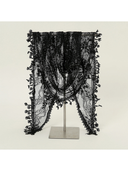 Black floral lace triangle scarf draped over a display stand