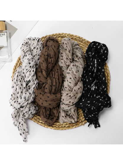 Four crinkled dot scarves displayed together in ivory, coffee, khaki and black