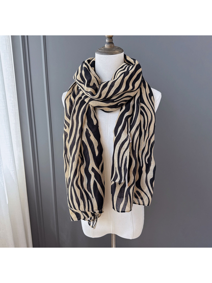 Brown animal-stripe scarf draped on a dress form