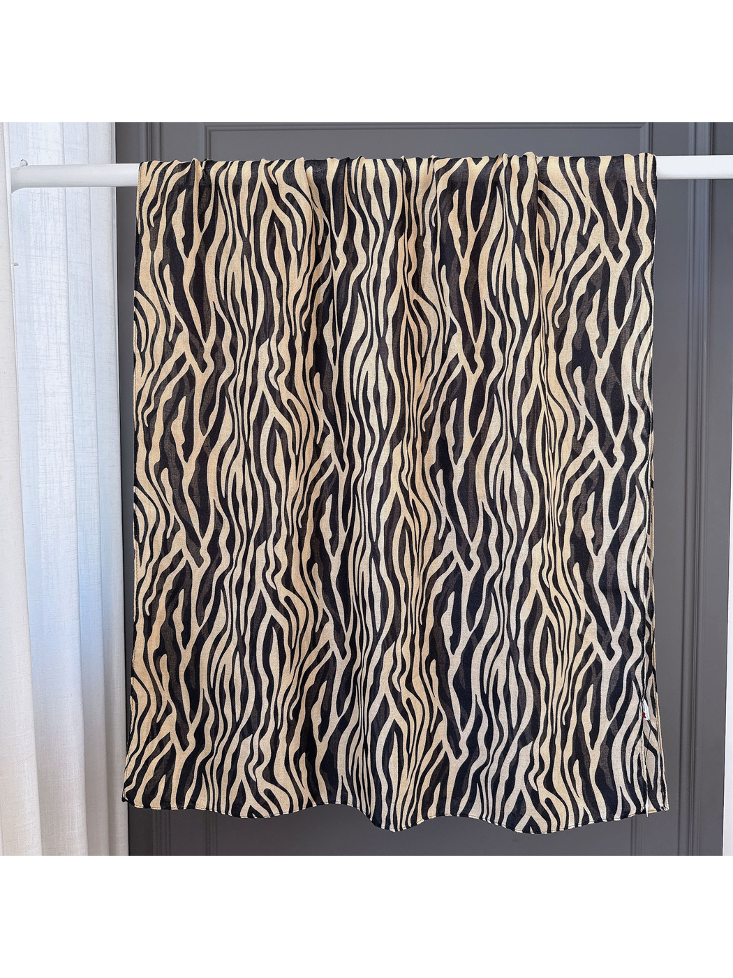 Brown animal-stripe scarf spread open to show its long rectangular shape