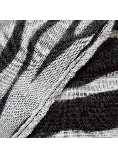 Close-up of the Black scarf's narrow stitched edge and woven-look texture