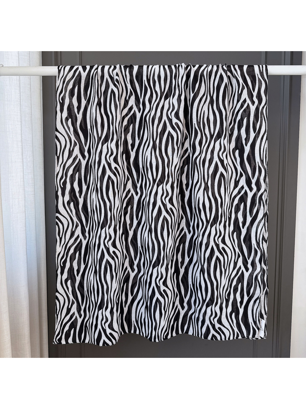 Black animal-stripe scarf spread open to show its long rectangular shape
